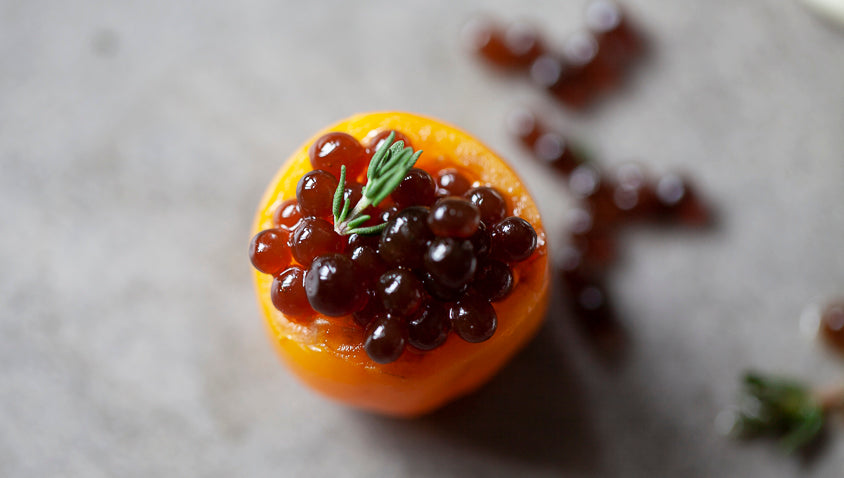 Cherry tomatoes with goat cheese, fake balsamic caviar and molecular vinaigrette