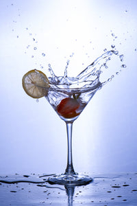 A cocktail glass captured mid-splash, exuding vibrancy and energy