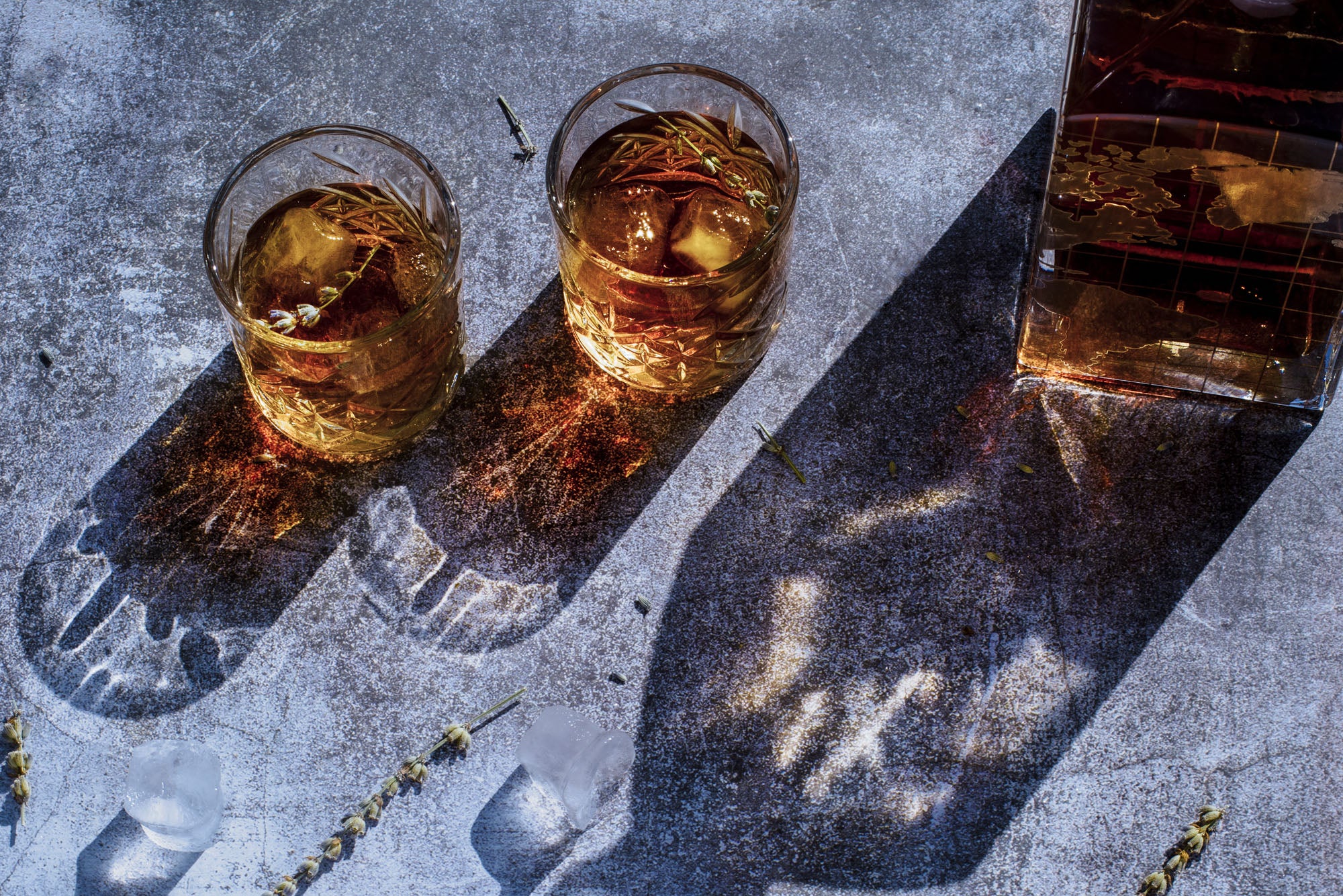 Whisky glasses and whisky bottle with hard lighting