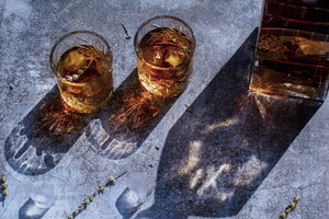 Whisky glasses and whisky bottle with hard lighting